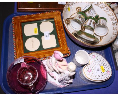 A ruby glass sugar bowl and cream jug decorated applied white trailing, a set of four Limoges green and gilt cabinet cups and