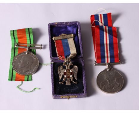 A silver gilt and enamel Russian Imperial Eagle Medal together with a WWII Defence Medal and service medal 