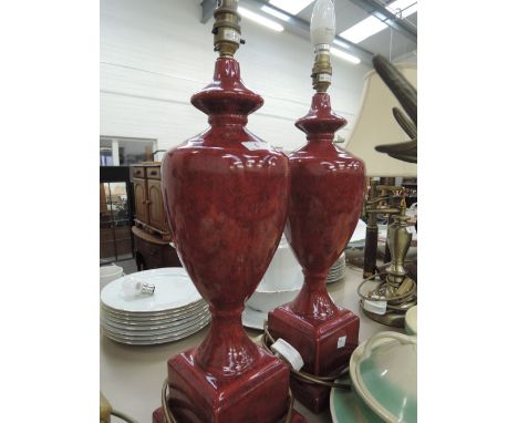 A pair of ceramic lamps on a square base 