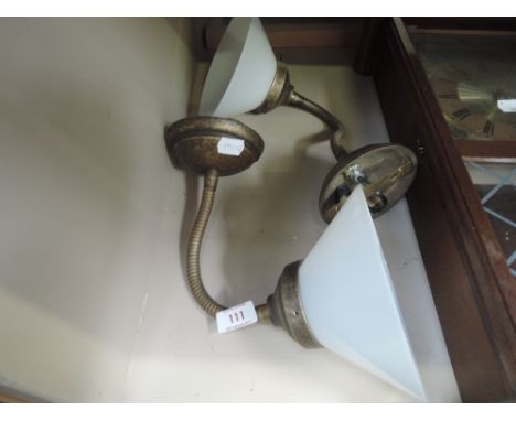 A pair of flexible brass effect wall light fittings