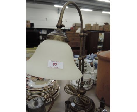 A brass table lamp in the form of a gas lamp