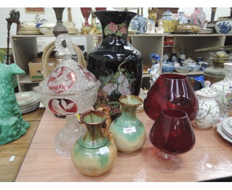 A cut glass bon-bon dish with etched bird decoration, a large black ceramic vase, two decorative ceramic pots and two red ove