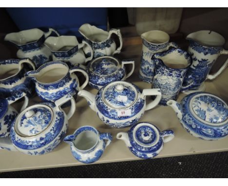 A shelf of blue and white tea pots and jugs including Burleigh and Wedgwood