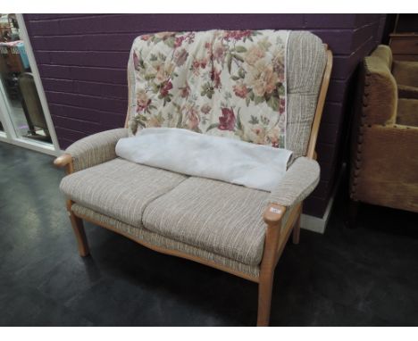 A light beech cottage style two seater settee