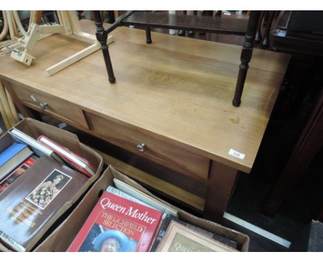 A modern light oak coffee table having frieze drawers and undertier