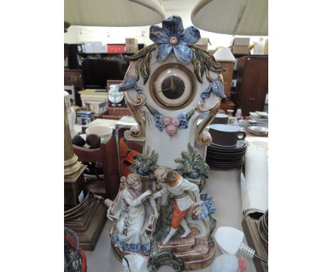 A mid 20th century continental style ceramic clock