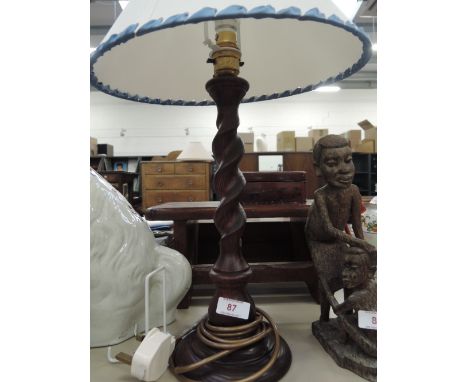A wood twist stem table lamp
