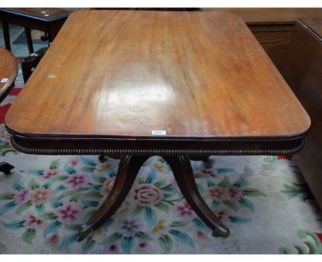 A post-Regency mahogany rounded rectangular breakfast table, moulded top above a deep beaded frieze, turned pillar, moulded s