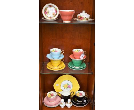 A Staffordshire Harlequin part tea set, for six, printed with roses, comprising cups, saucers, side plates, milk jug and suga