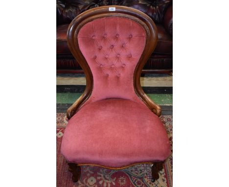 A Victorian mahogany spoonback nursing chair, button back terminating in scrolls, 63.5cm wide