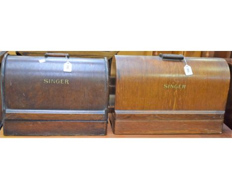 An early 20th century hand crank singer sewing machine; another similar (2)