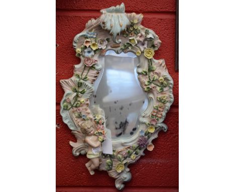 A pair of Continental ceramic wall mirrors, floral and cherub decoration, approx 48cm in length (2)