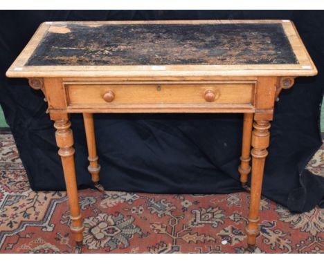 A 20th century ash side table, oversailing rounded rectangular top with inset tooled leather writing surface supported by fou