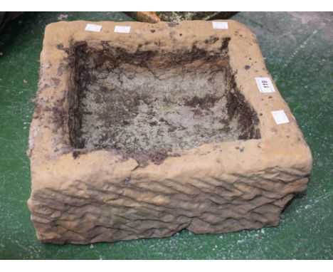 A small gritstone trough, 16.5cm high, 33cm wide