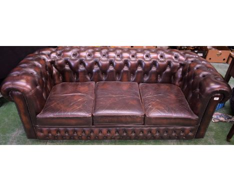 A scroll arm Chesterfield reception sofa, buttoned leather upholstery, 190cm wide