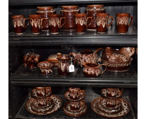 A Cornish Kernewek ceramic treacle glazed tea service, including Chicken egg basket, piggy bank, three storage jars, teapot, 