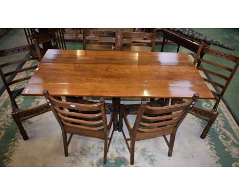 A 20th century oak trestle type dining table, rectangular top above a deep carved frieze, harp shaped supports, 182cm long; a