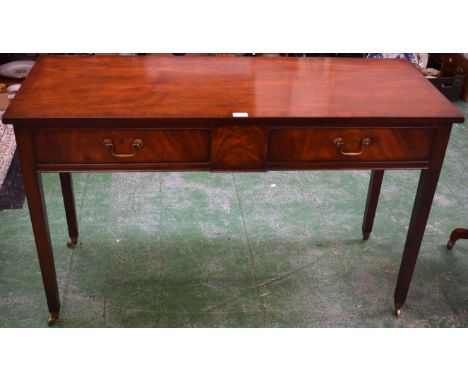 A mahogany side table, 'crossbanded' rectangular top above a pair of frieze drawers, tapered square legs, brass casters, labe