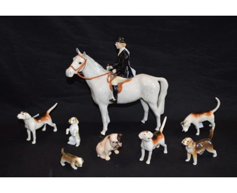 A Beswick female hunter, astride dappled mare, printed mark; a Beswick Fox Hound; two others, similar; other ceramic dogs and