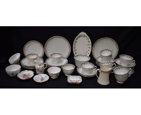 Ceramics - an early 20th century part tea service, floral swags on white ground including cups and saucers, side plates, larg