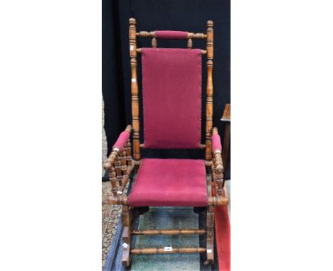 An American spring rocking chair, fabric upholstery; a corner cabinet, of small proportions, carved door; an inlaid side tabl