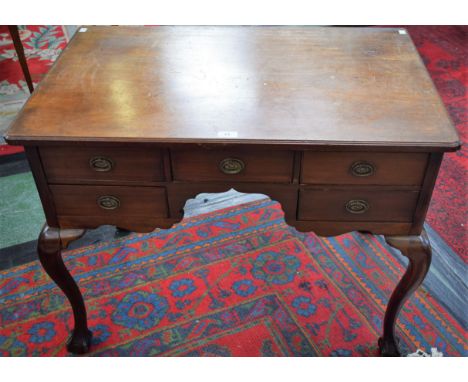 A 19th century mahogany side table, shaped rectangular top above an arrangement of five short drawers, shaped apron, hipped c