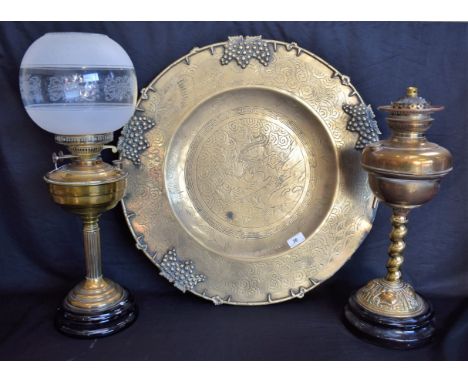 An early 20th century brass oil lamp, later converted to electricity, spirally cast column, marked Hasag; another, Duplex Twi