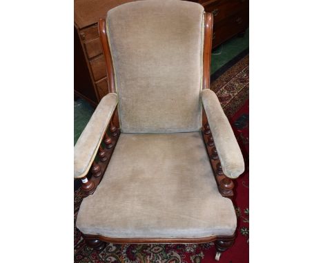 A Victorian mahogany library chair, scrolling back, balustrade arm supports, stuffed over upholstery, ceramic casters