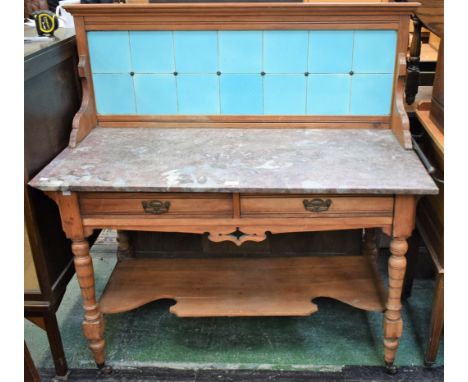 An early 20th century hardwood washstand, stone top with high tiled half gallery above a pair of short drawers and shaped und