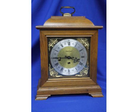 MID/LATE 20TH CENTURY GERMAN OAK BRACKET CLOCK
polished brass dial marked 'Kieninger' with four mask details to the corners, 