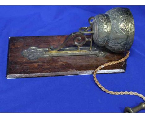 20TH CENTURY BRASS BELL 
inscribed 'Leo Aqvila Pelicanvs', mounted on rectangular shaped oak wooden bracket