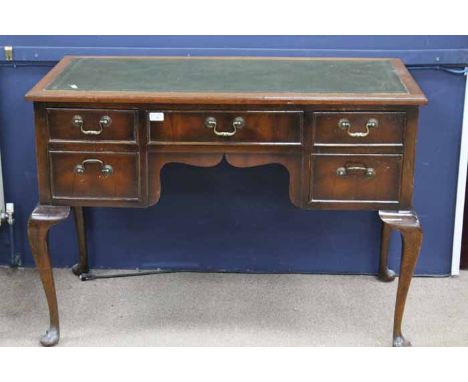 20TH CENTURY MAHOGANY KNEEHOLE DESK
the central long drawer flanked by two sets of graduated short drawers, over cabriole leg