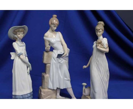 THREE LARGE LLADRO AND NAO LADY FIGURES
including a lady reading leaning on a wall, a lady with a dog in her arms and a lady 