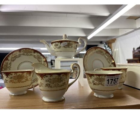 A tea set consisting of teapot, 2 cups &amp; saucers, sugar bow &amp; milk jug in decorative gold design