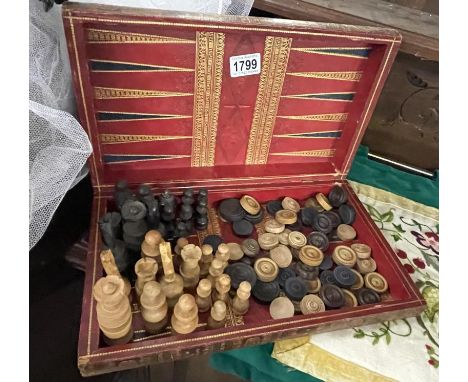 A decorative box with draughts &amp; chess pieces