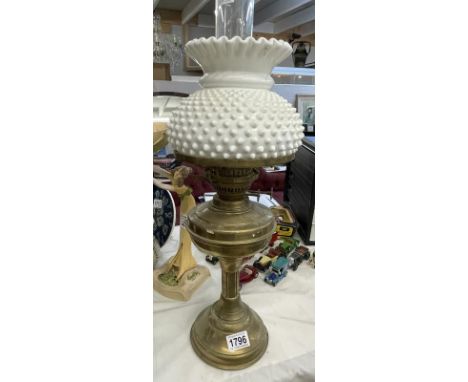An oil lamp with white shade