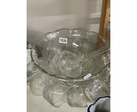A glass punch bowl with 10 attached glass cups &amp; ladle