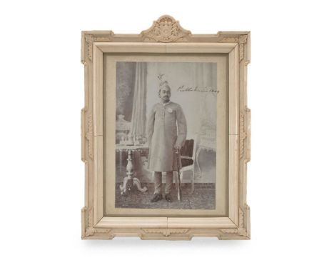 ϒ Sir Prabhu Narajan Singh, Maharaja of Benares (ruled 1889-1931), a full length portrait photograph, in an interior with sil