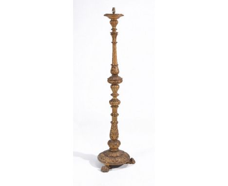 A carved giltwood standard lamp, the column with acanthus carved and fluted on a triform base with paw feet 164 cm high inclu