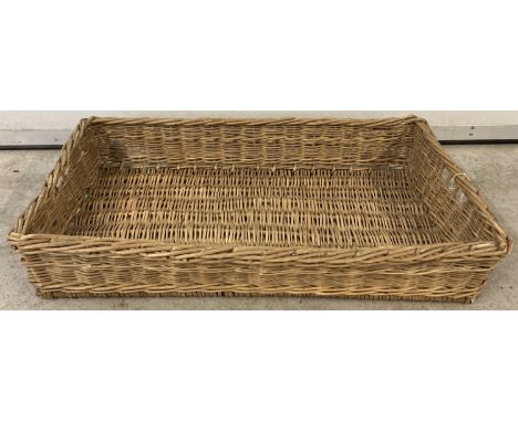A vintage wicker rectanglur shaped bread basket with carry handles.  Approx. 15 x 82 x 48cm.
