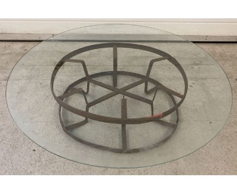 A garden low coffee table made from a vintage metal hose reel with circular removeable glass top.  Top approx. 89 cm diameter