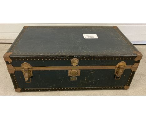 A vintage Watajoy metal banded leatherette travelling trunk with makers nameplate to front. Leather carry handles (1 a/f). Pa