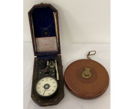 2 vintage tools. A vintage cased Smiths lathe cutting and surface speed gauge. Together with a vintage leather cased tape mea