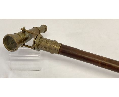 A reproduction wood and brass walking stick with swivel top telescope/compass handle.  Approx. 95.5cm long in folded position