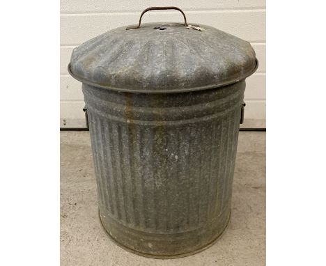 A vintage galvanised metal dustbin with lid and carry handles.  Approx. 52cm tall.
