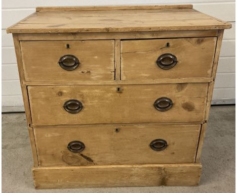 A vintage rustic pine 2 over 2 chest of drawers with metal drop down handles. Some drawers need attention. Approx. 80 x 81 x 