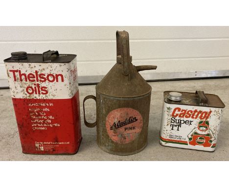 3 vintage metal fuel cans. An Aladdin Pink Paraffin can, a Thelson Oils 1 gallon oil can and a Castrol Super TT motorcycle ½ 