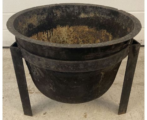 A vintage cast iron garden fire pit with handmade 3 legged stand.  Approx. 42cm tall x 51cm diameter.