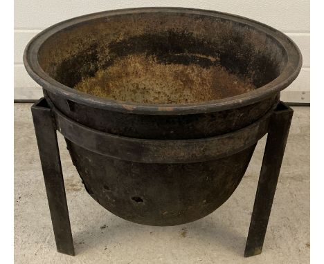 A vintage cast iron garden fire pit with handmade 3 legged stand.  Approx. 43cm tall x 50cm diameter.