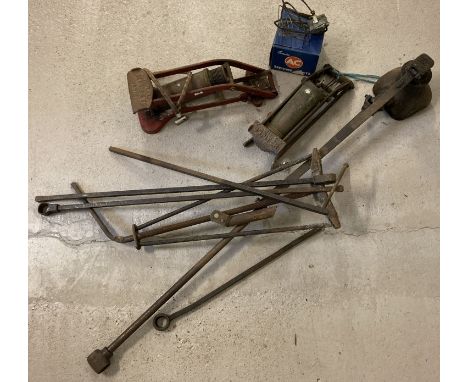 A large vintage vehicle jack with attachments together with 2 vintage foot pumps and a car temperature gauge. 